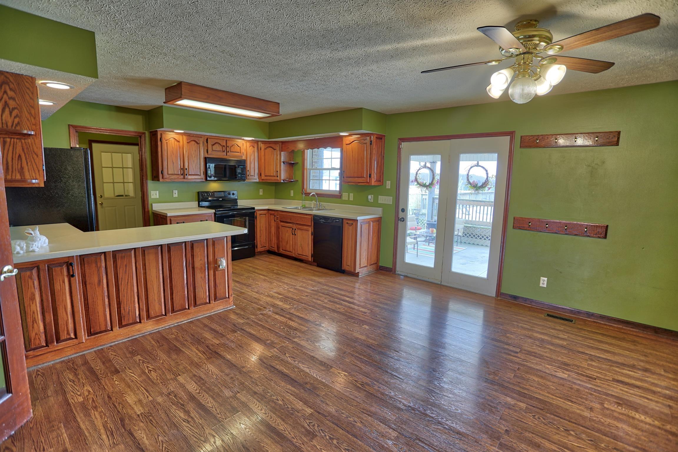 4322 Dot Road Springfield, TN 37172 - Photo 2 of 22 a kitchen with granite countertop wooden floors a sink and stainless steel appliances