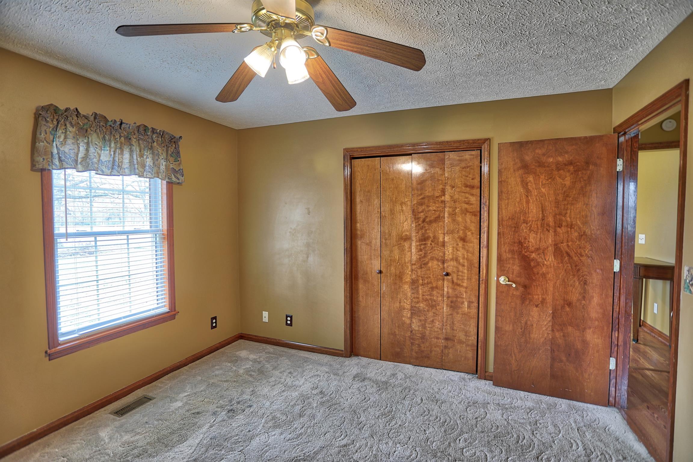 4322 Dot Road Springfield, TN 37172 - Photo 14 of 22 a view of an empty room with window and chandelier fan