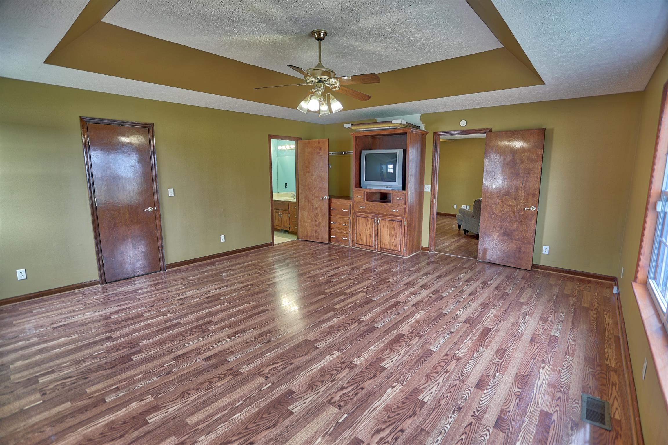 4322 Dot Road Springfield, TN 37172 - Photo 3 of 22 a view of a room with wooden floor and a ceiling fan