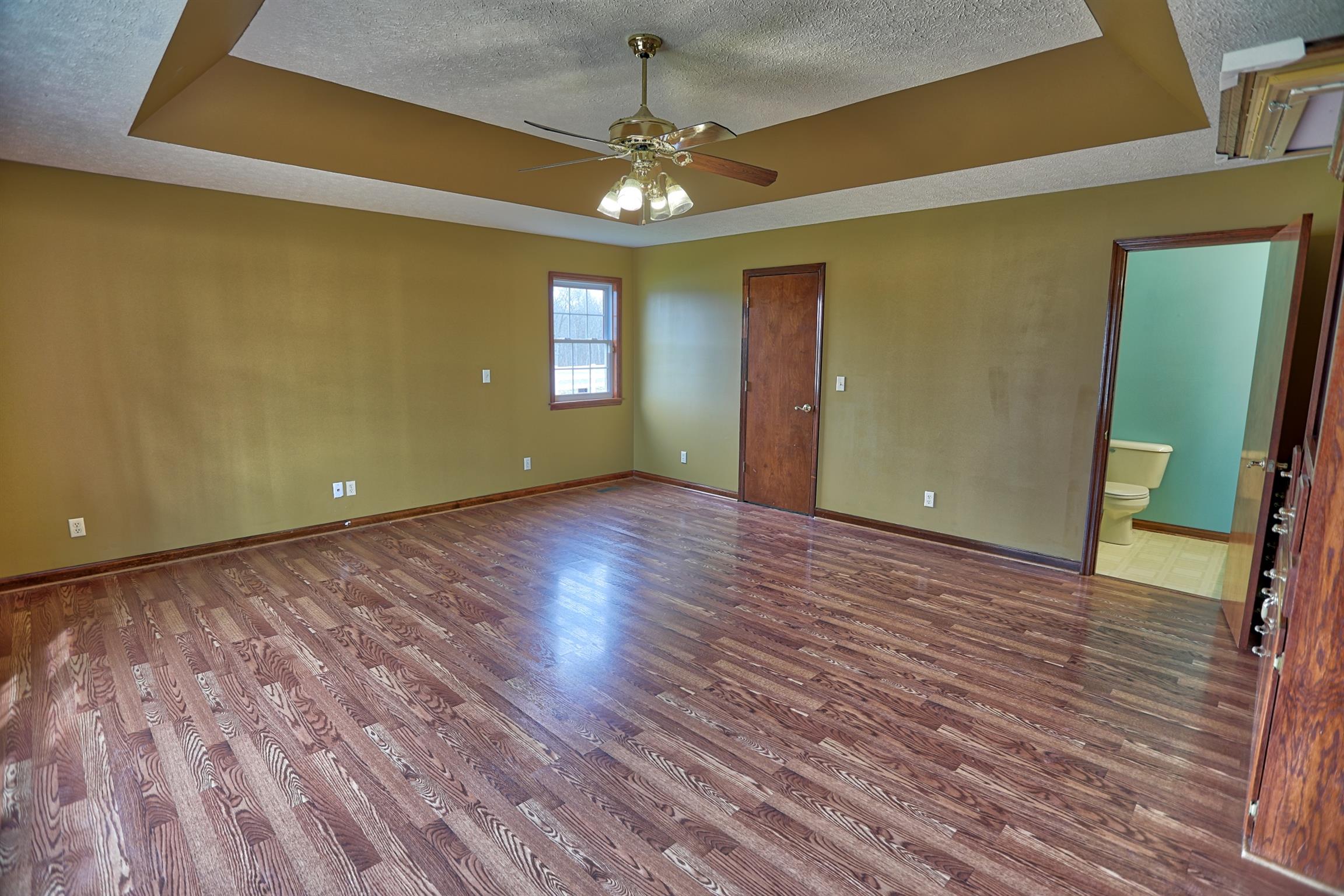 4322 Dot Road Springfield, TN 37172 - Photo 10 of 22 a view of an empty room with wooden floor and a window