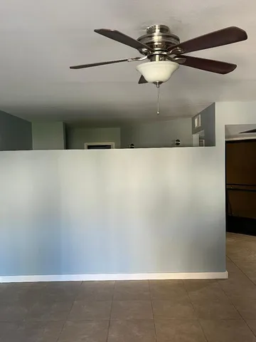 a view of a refrigerator in kitchen and an empty space