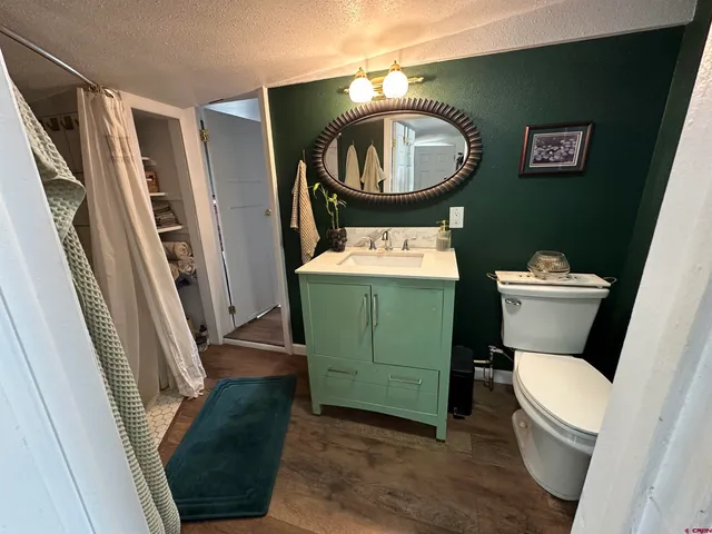 a bathroom with a toilet and a mirror