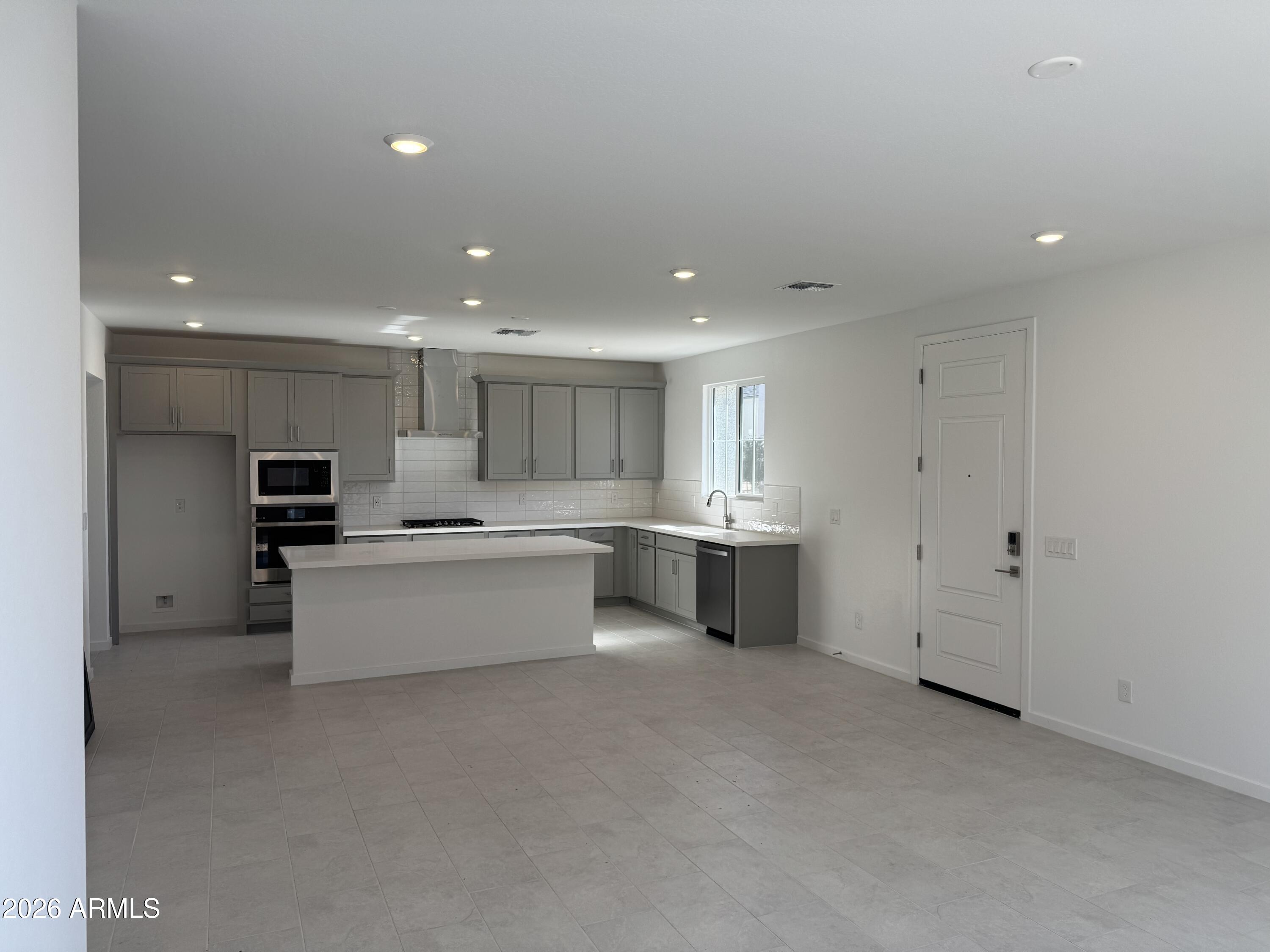2460 West Maximo Way Phoenix, AZ 85085 - Photo 6 of 14 a large white kitchen with lots of counter space and a sink