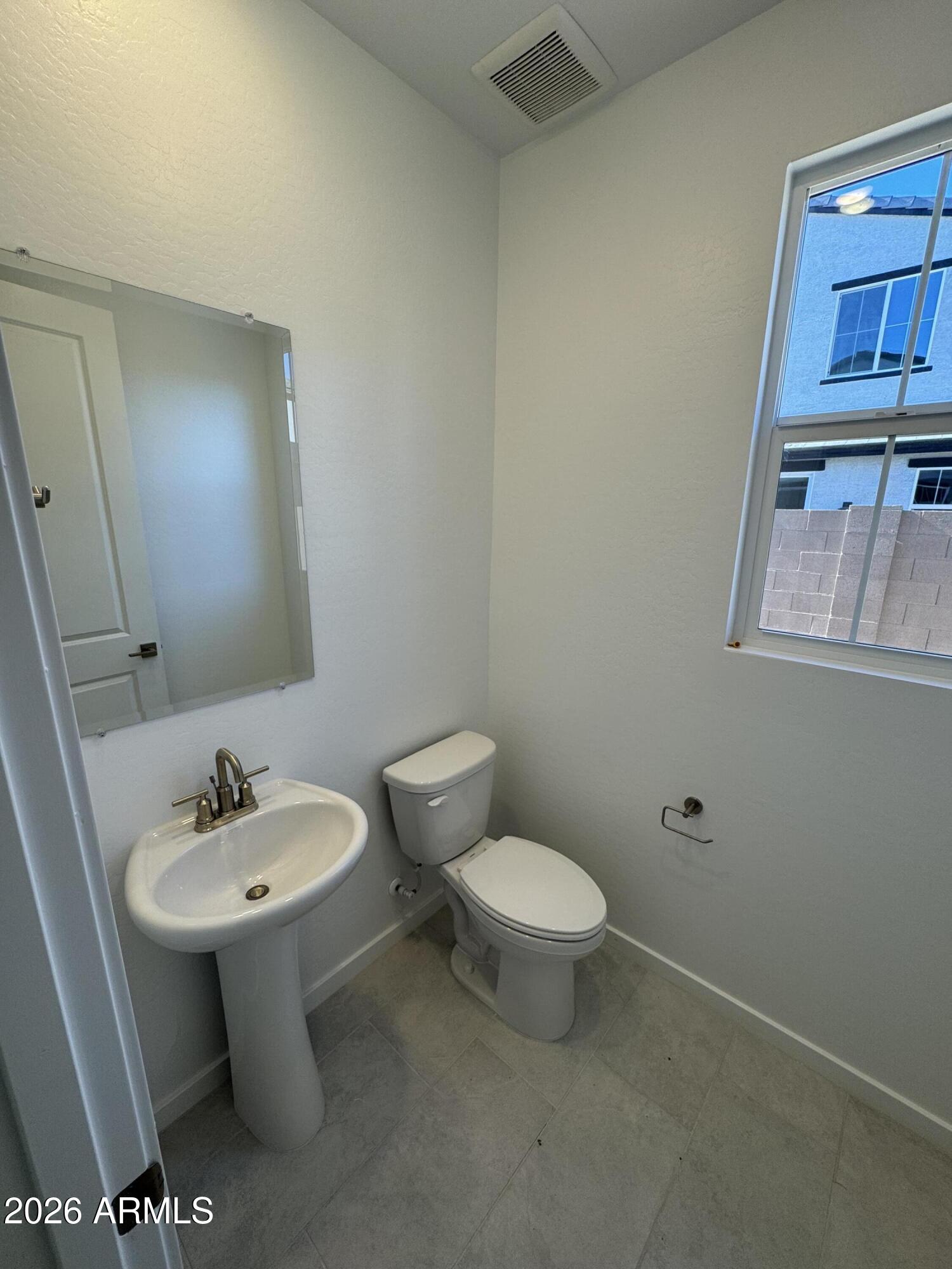 2460 West Maximo Way Phoenix, AZ 85085 - Photo 8 of 14 a bathroom with a sink toilet and a mirror
