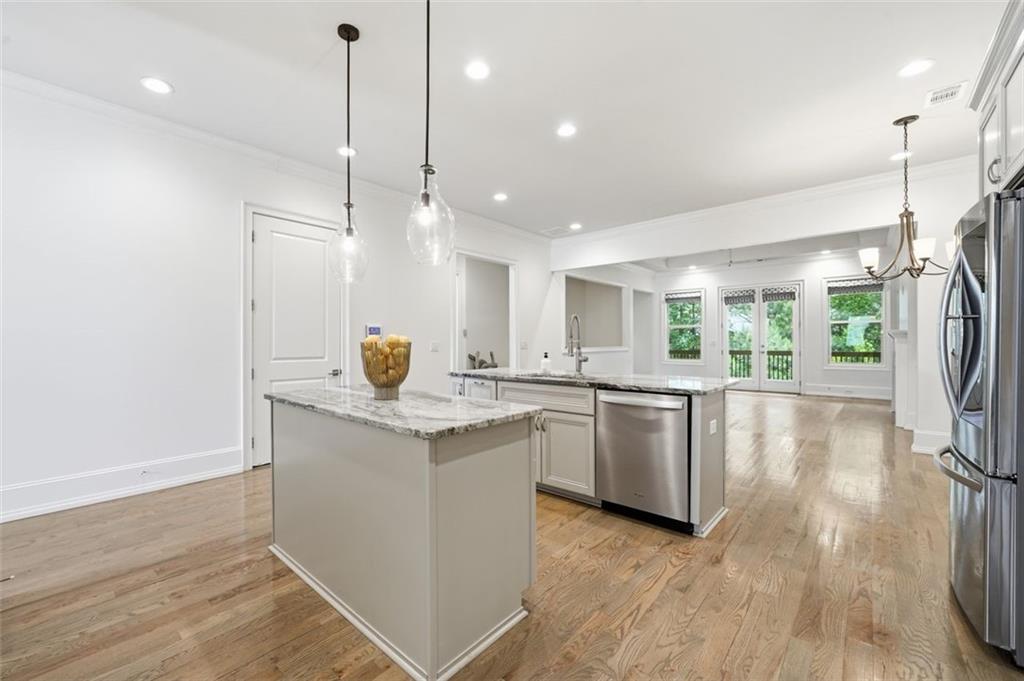337 Rosshandler Road Suwanee, GA 30024 - Photo 7 of 45 a kitchen with a sink appliances and wooden floor