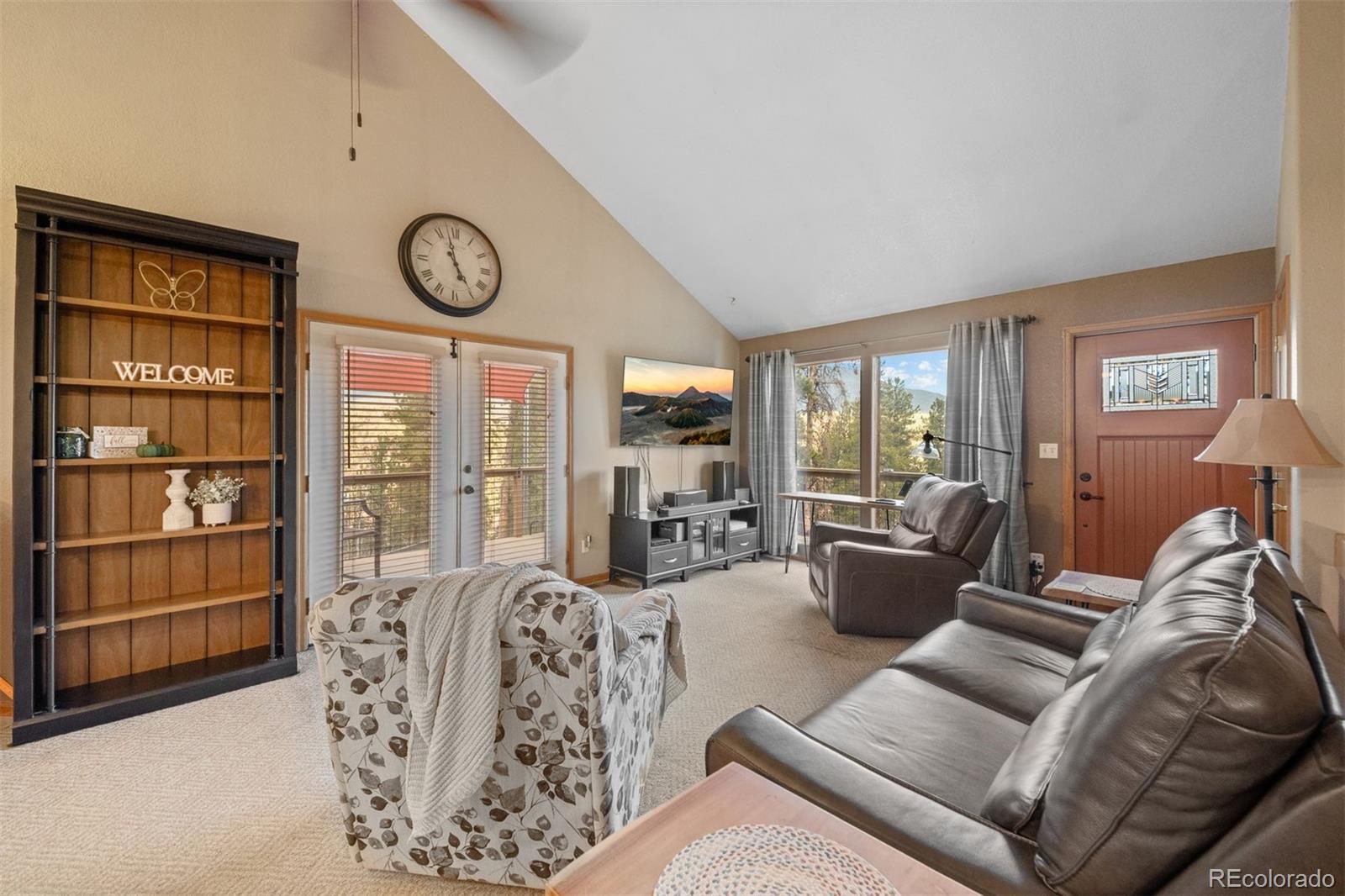 609 Gold Flake Terrace Bailey, CO 80421 - Photo 12 of 47 a living room with furniture a clock and a large window