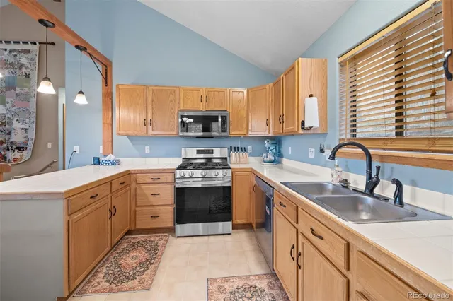 a kitchen with stainless steel appliances granite countertop a sink stove and cabinets