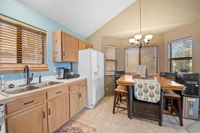 a kitchen that has a lot of cabinets in it and appliances