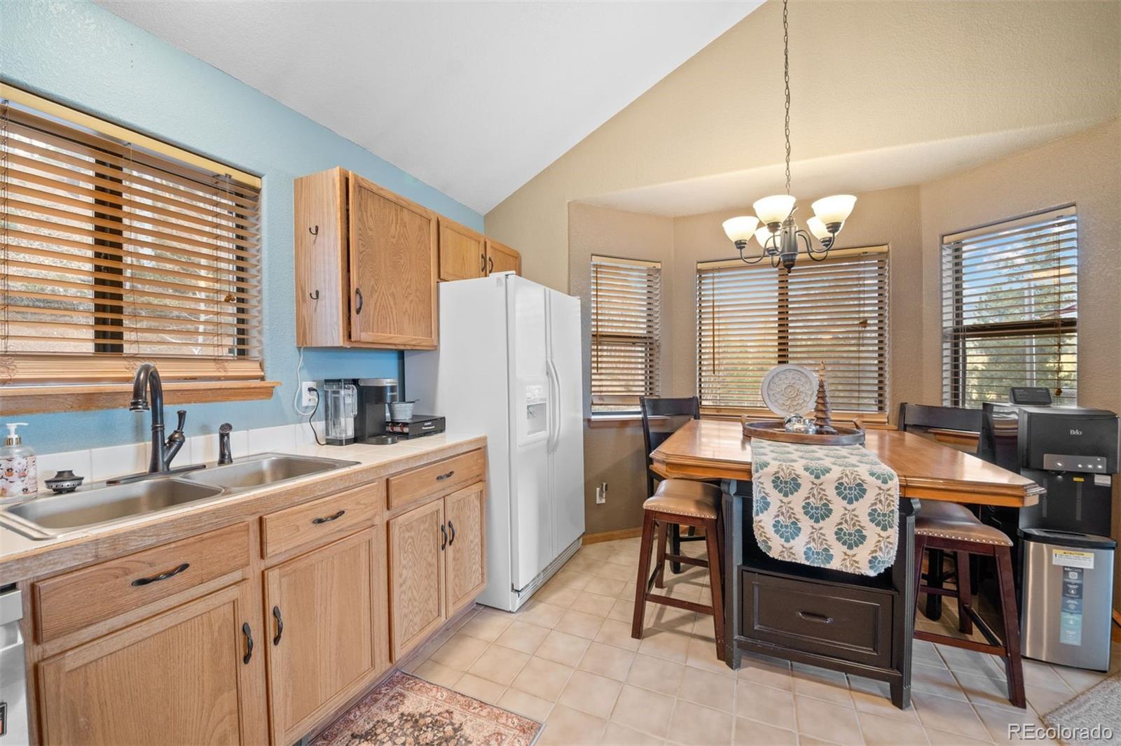 609 Gold Flake Terrace Bailey, CO 80421 - Photo 13 of 47 a kitchen that has a lot of cabinets in it and appliances