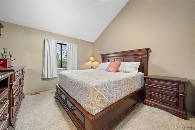 a bed sitting in a bedroom next to a window