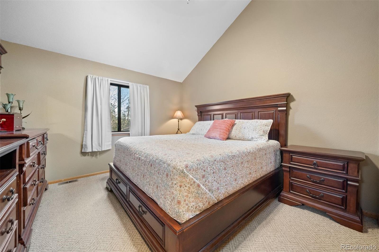 609 Gold Flake Terrace Bailey, CO 80421 - Photo 15 of 47 a bed sitting in a bedroom next to a window