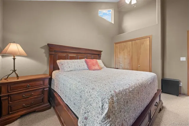 a bedroom with a bed and a lamp