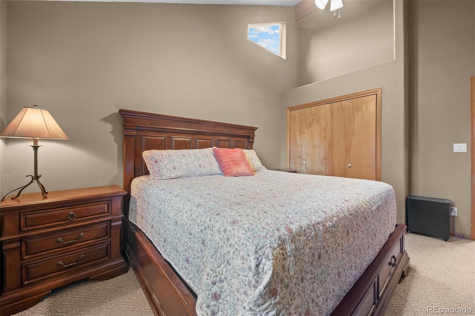 609 Gold Flake Terrace Bailey, CO 80421 - Photo 18 of 47 a bedroom with a bed and a lamp