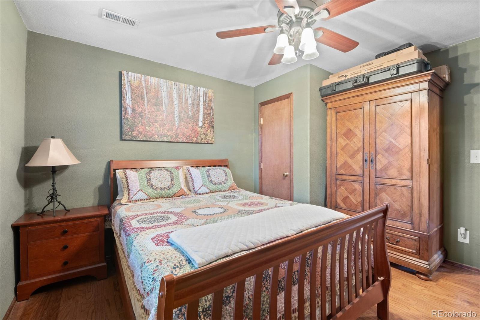 609 Gold Flake Terrace Bailey, CO 80421 - Photo 26 of 47 a bedroom with a bed and a chandelier