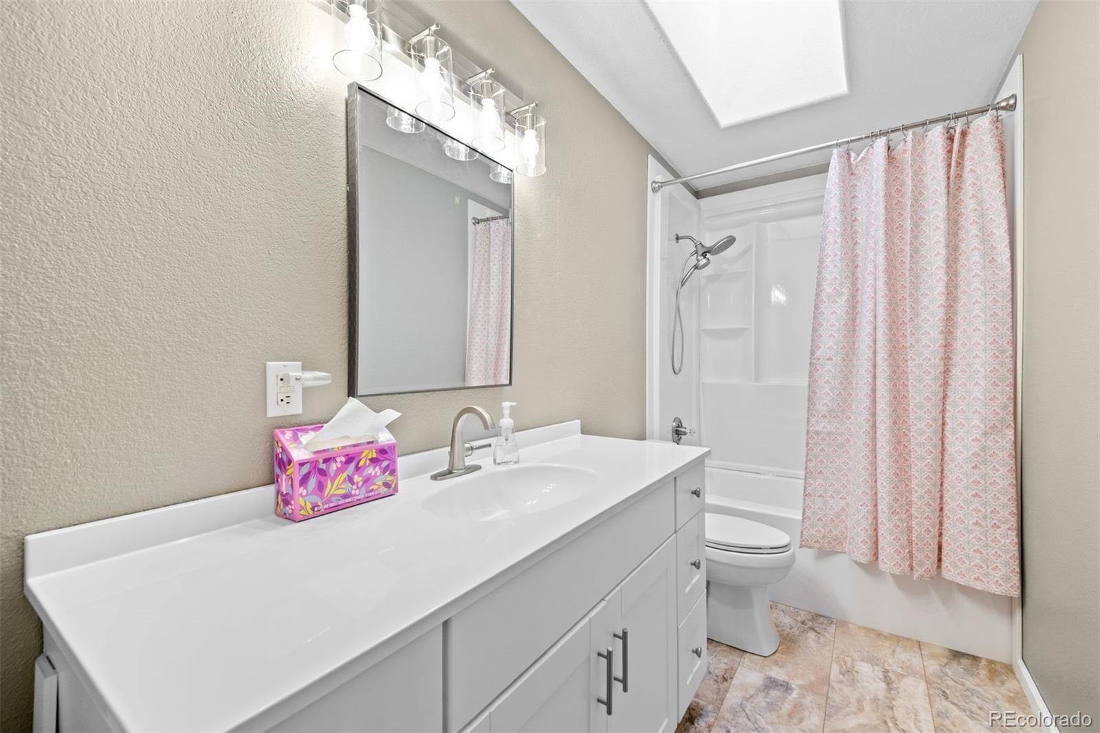 609 Gold Flake Terrace Bailey, CO 80421 - Photo 27 of 47 a bathroom with a sink a toilet and shower curtain