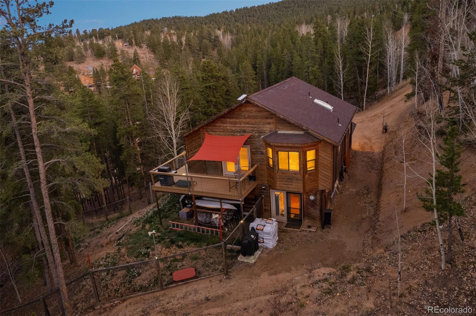 609 Gold Flake Terrace Bailey, CO 80421 - Photo 28 of 47 a backyard of a house with barbeque oven table and chairs