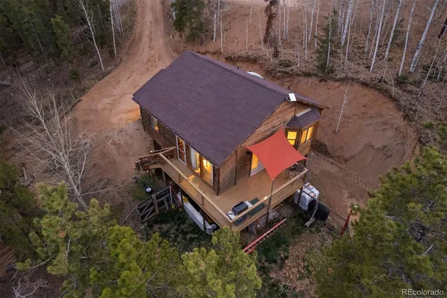 an aerial view of a house with a yard