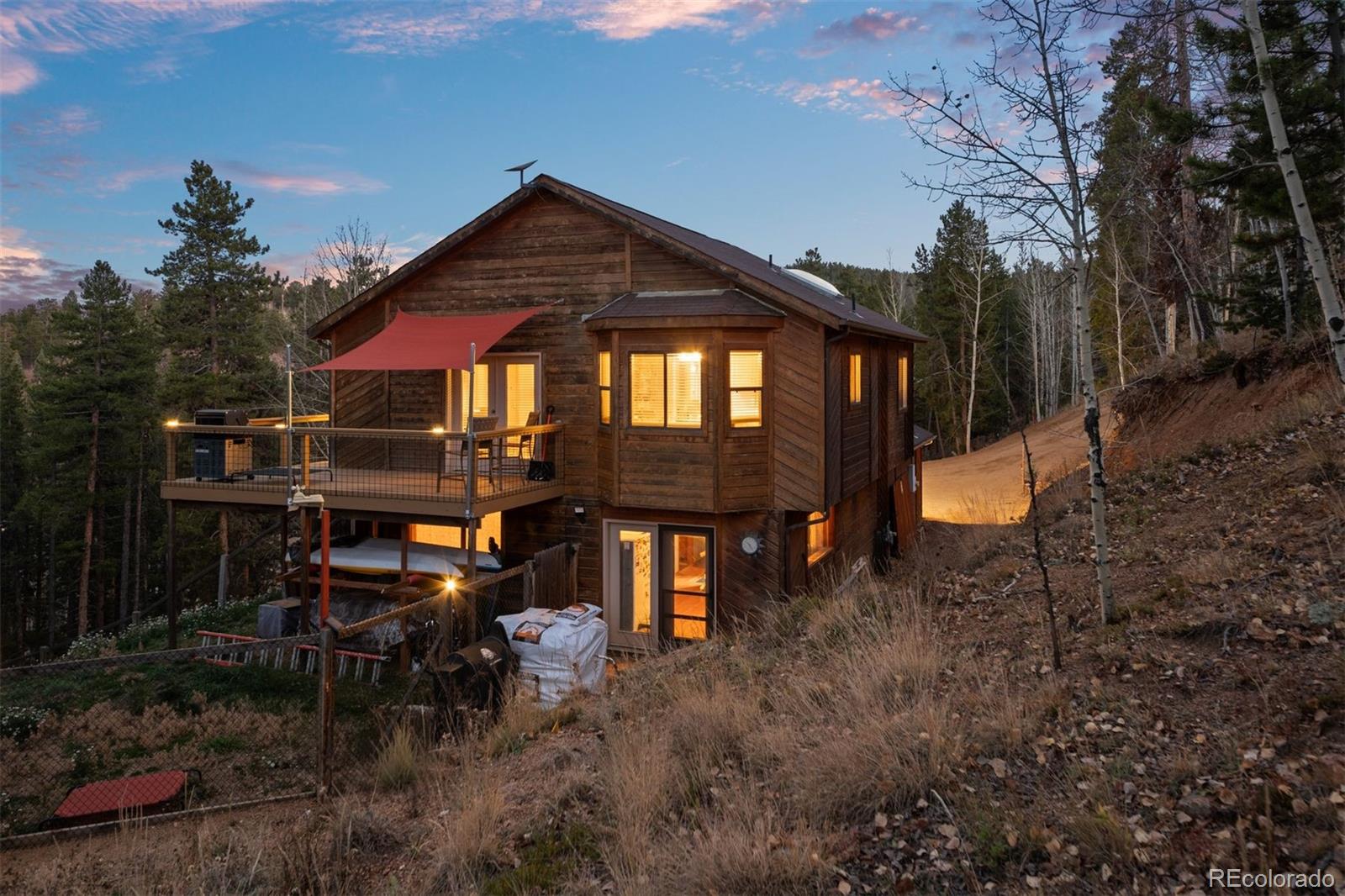 609 Gold Flake Terrace Bailey, CO 80421 - Photo 33 of 47 a front view of a house with a yard