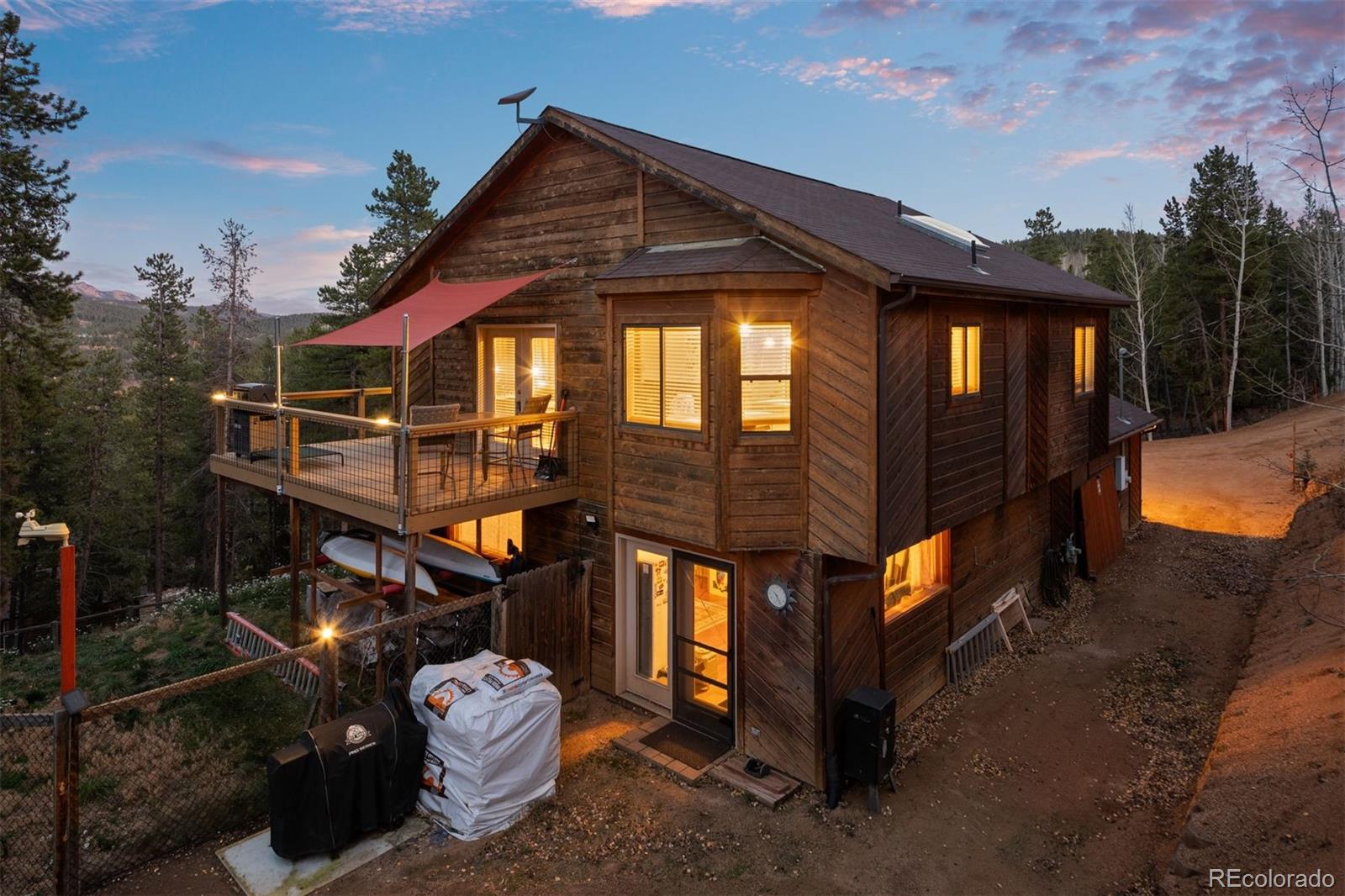 609 Gold Flake Terrace Bailey, CO 80421 - Photo 34 of 47 a front view of a house with a yard