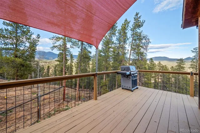 a view of balcony with wooden floor and lake view