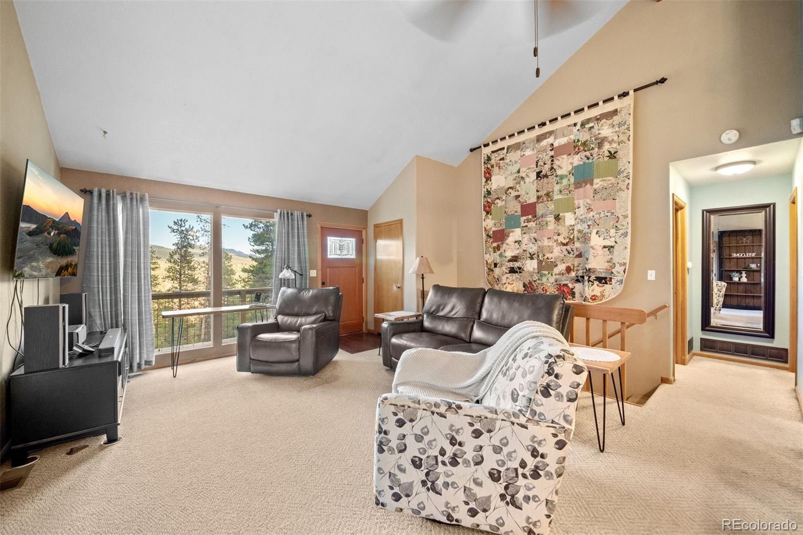 609 Gold Flake Terrace Bailey, CO 80421 - Photo 10 of 47 a living room with furniture and a large window
