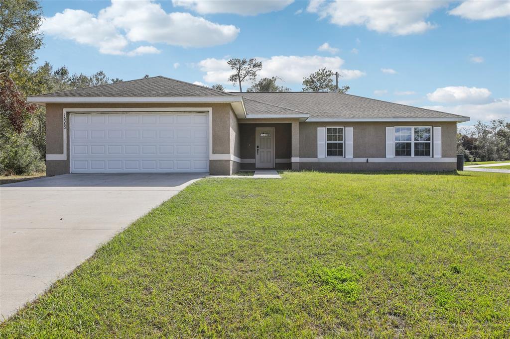 16060 Southwest 21st Terrace Road Ocala, FL 34473 - Photo 1 of 1 a front view of a house with a garden and yard