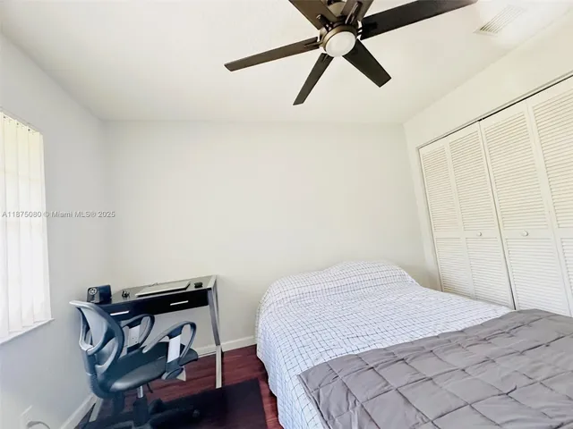 a bedroom with a bed and a dresser in it