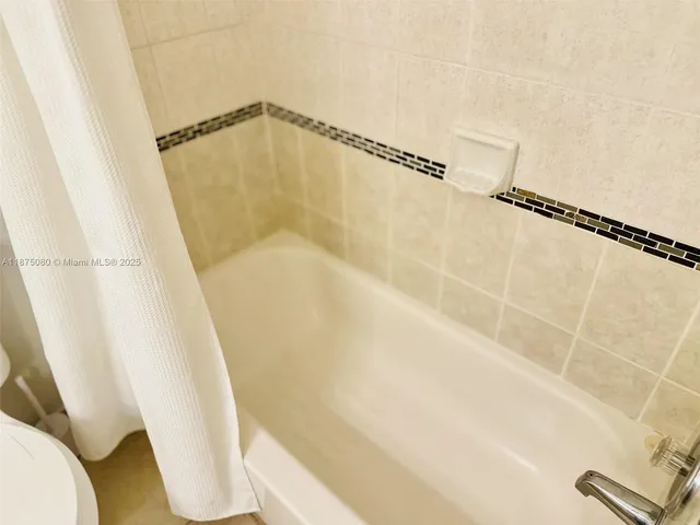 a bathroom with a shower and a toilet