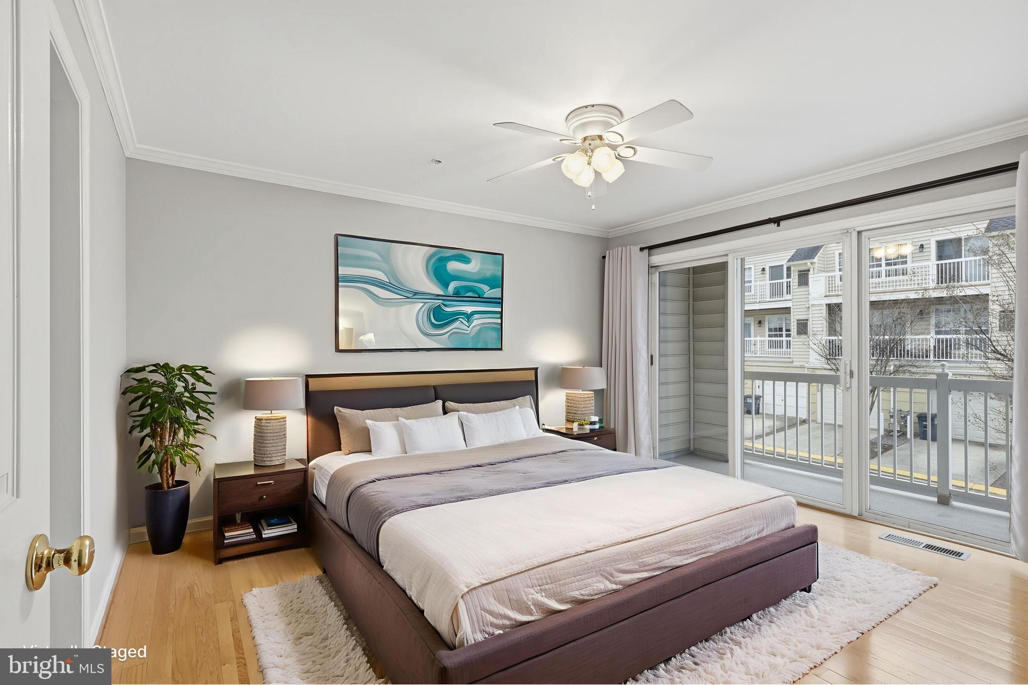 1934 Crescent Park Drive, Unit 28A Reston, VA 20190 - Photo 14 of 38 a bedroom with a large bed and a chandelier