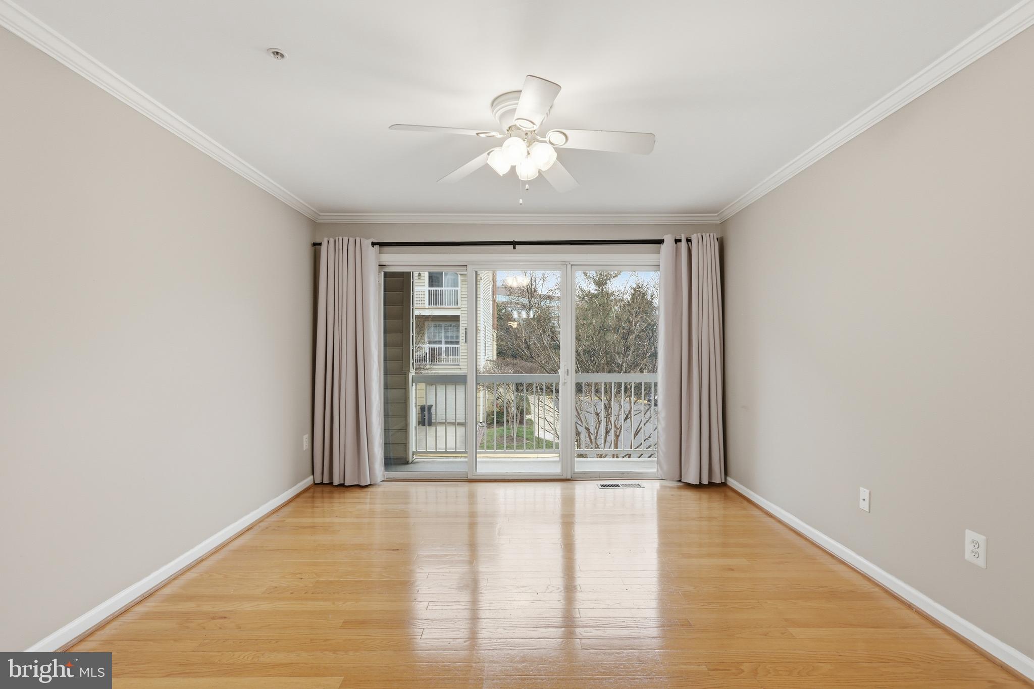 1934 Crescent Park Drive, Unit 28A Reston, VA 20190 - Photo 15 of 38 a view of an empty room with wooden floor and a window