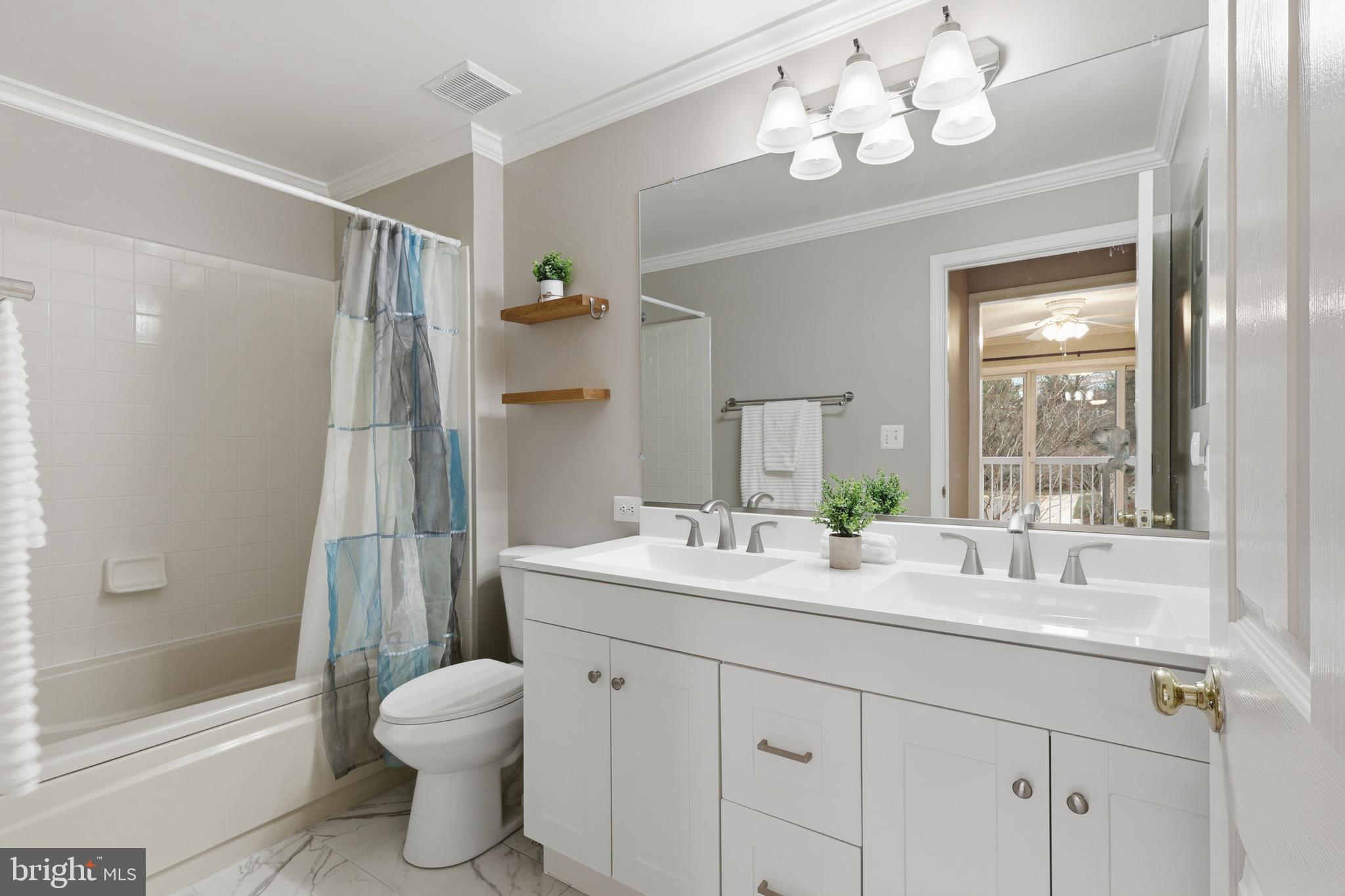 1934 Crescent Park Drive, Unit 28A Reston, VA 20190 - Photo 19 of 38 a bathroom with a sink a toilet and shower