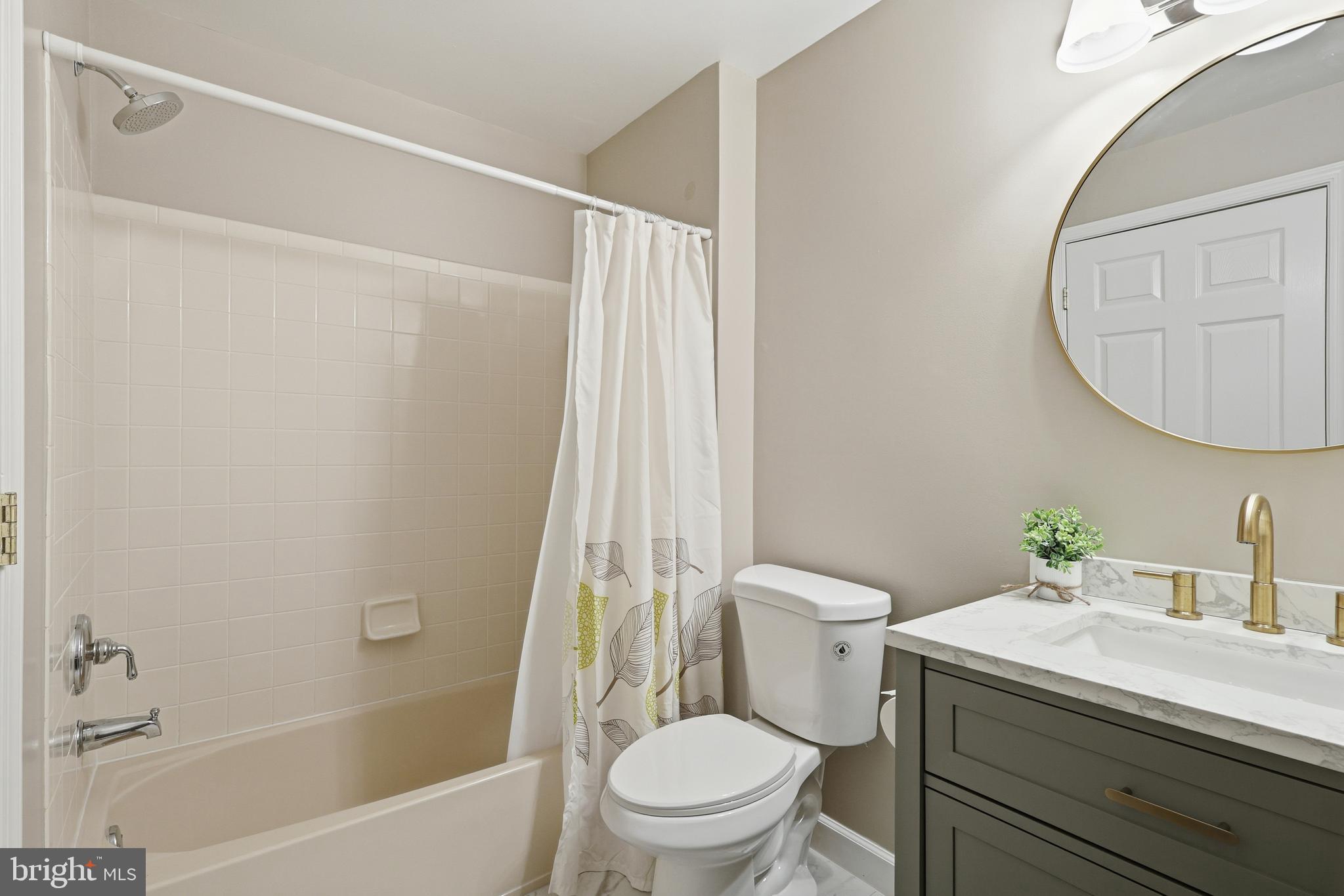 1934 Crescent Park Drive, Unit 28A Reston, VA 20190 - Photo 22 of 38 a bathroom with a sink a toilet and a mirror
