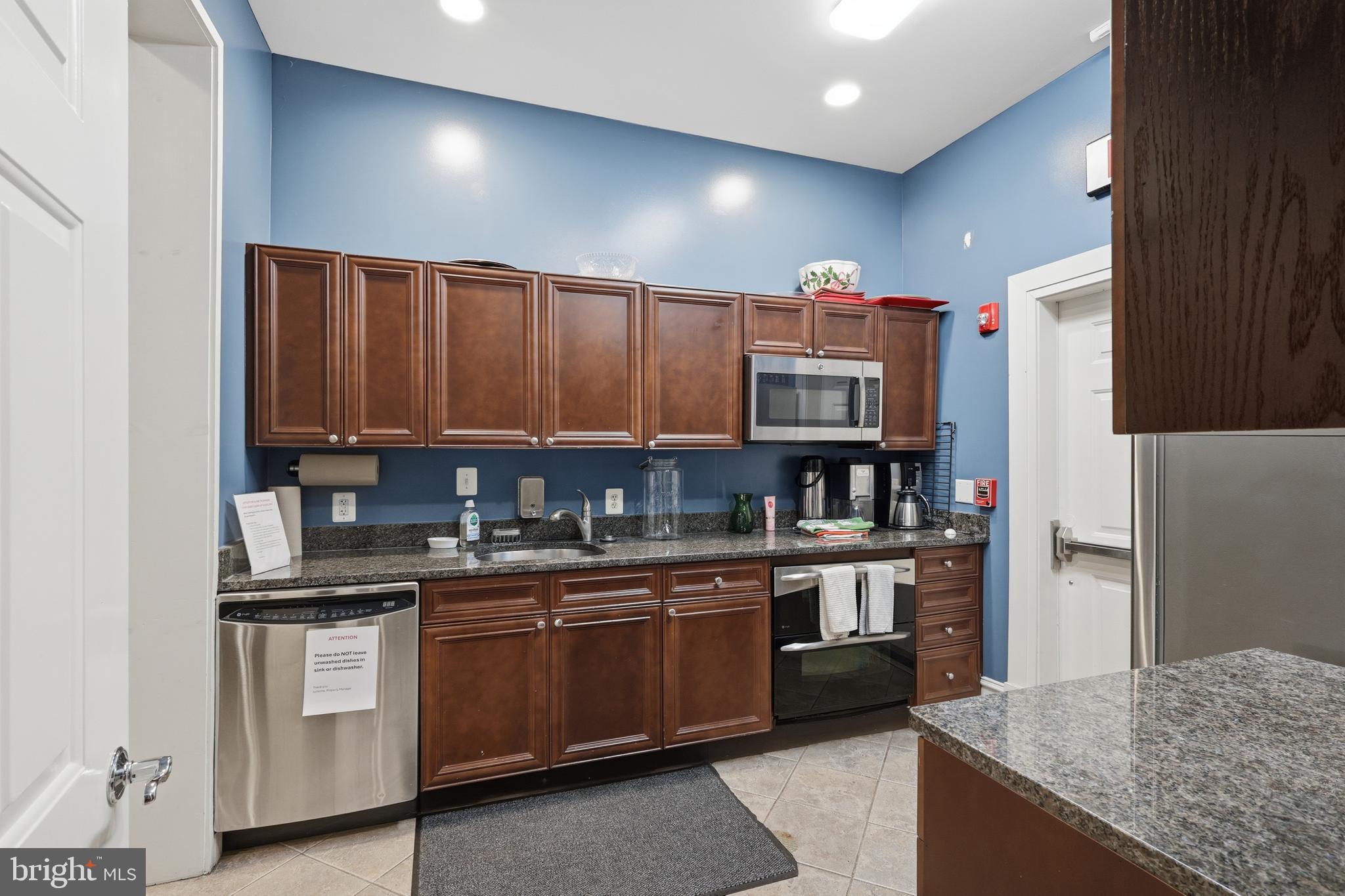 1934 Crescent Park Drive, Unit 28A Reston, VA 20190 - Photo 32 of 38 a kitchen with stainless steel appliances granite countertop a refrigerator and a sink