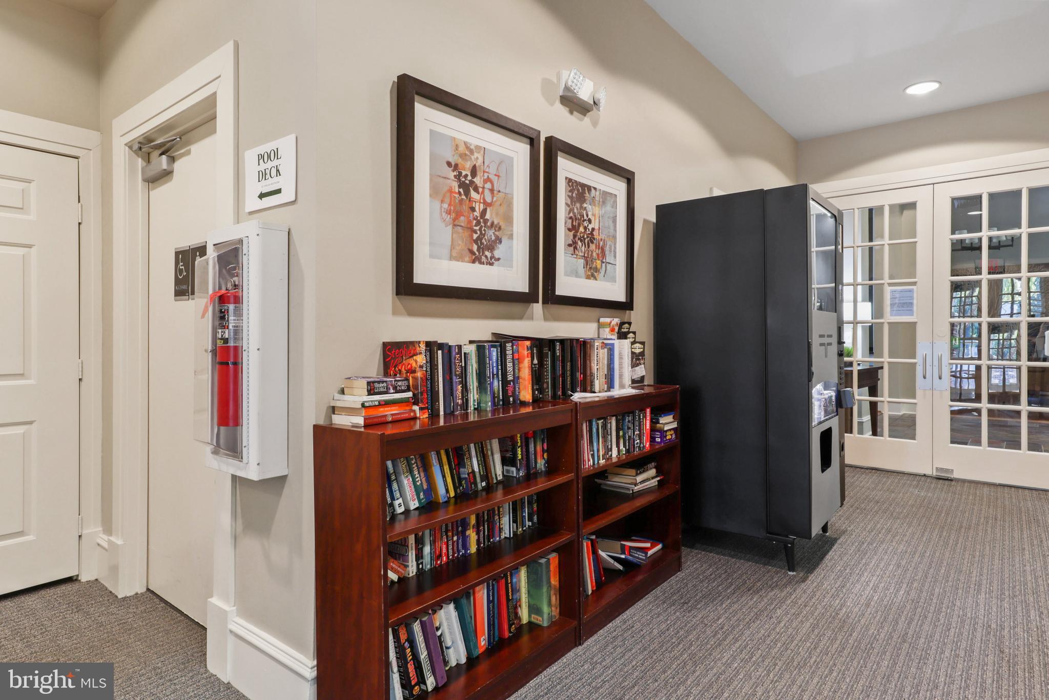 1934 Crescent Park Drive, Unit 28A Reston, VA 20190 - Photo 34 of 38 a living room with large book shelf and a window