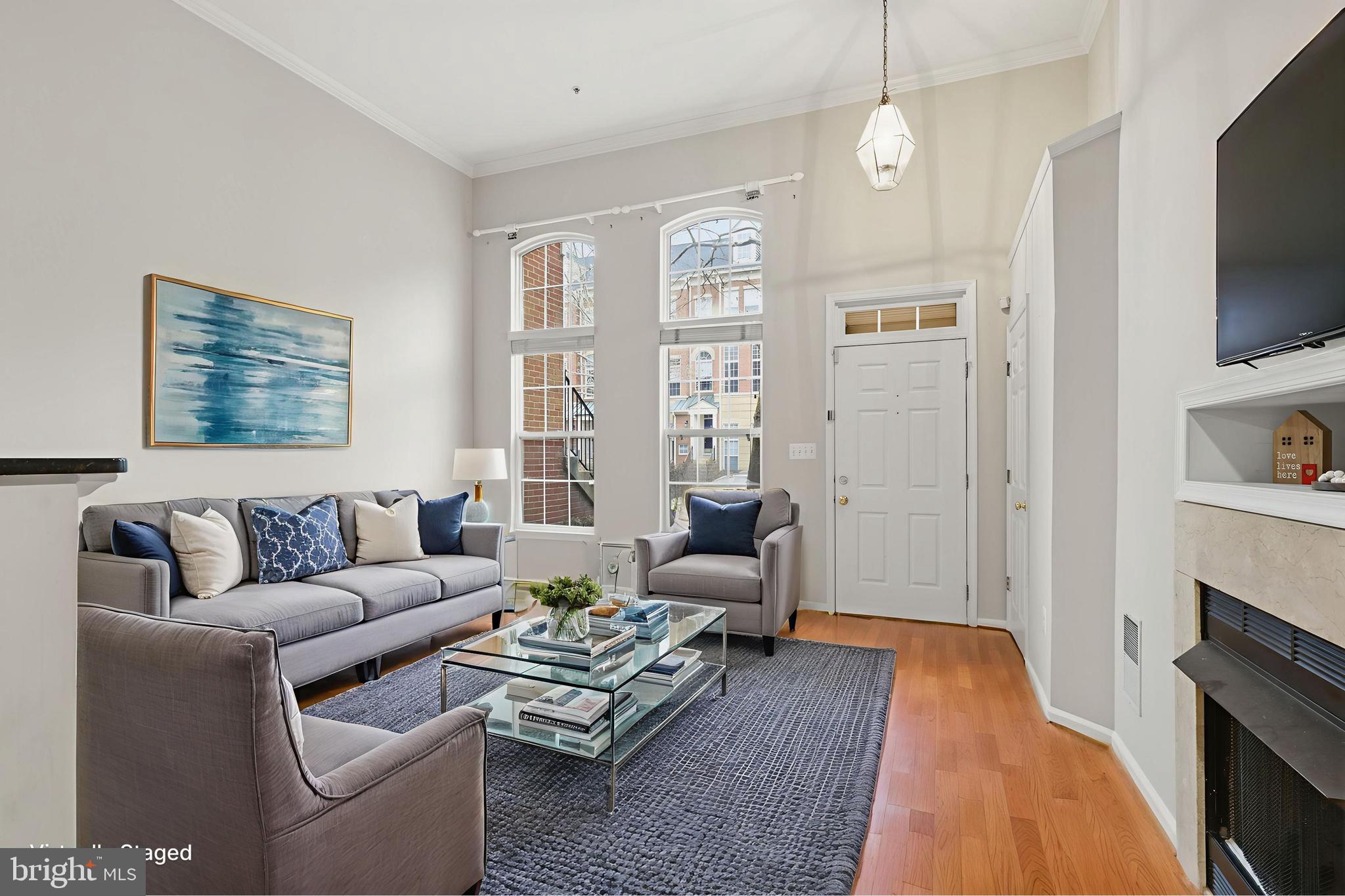 1934 Crescent Park Drive, Unit 28A Reston, VA 20190 - Photo 5 of 38 a living room with furniture fireplace and a flat screen tv