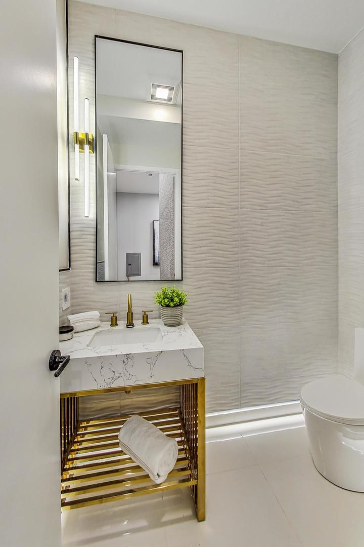 2024 West Irving Park Road, Unit 304 Chicago, IL 60618 - Photo 8 of 12 a bathroom with a sink a toilet and tub