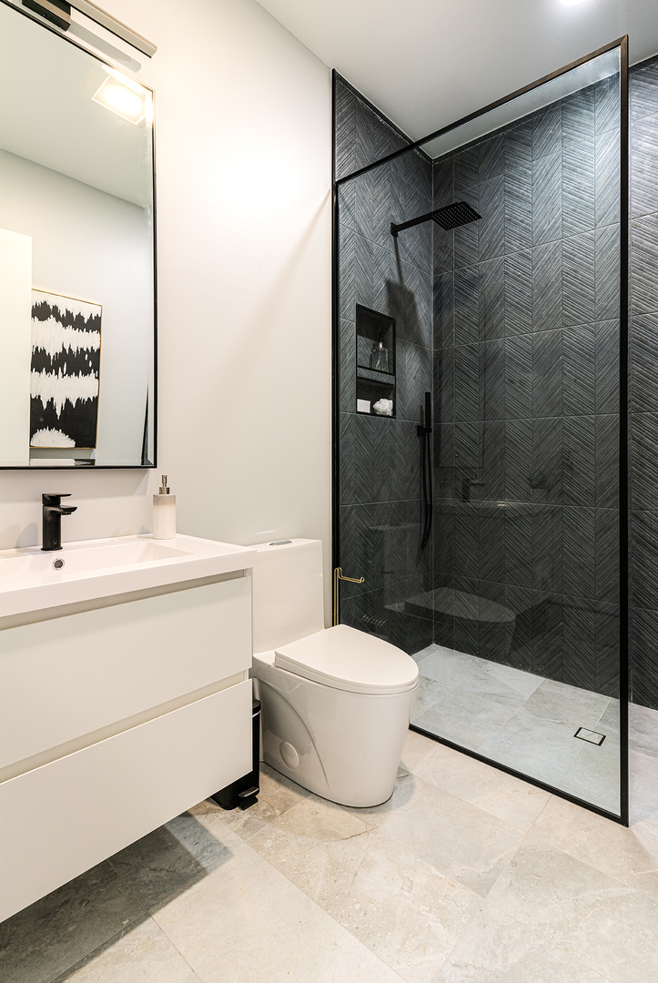 2024 West Irving Park Road, Unit 304 Chicago, IL 60618 - Photo 9 of 12 a bathroom with a sink a toilet and shower