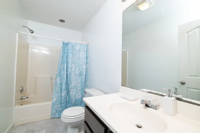 a bathroom with a sink a toilet and a bathtub