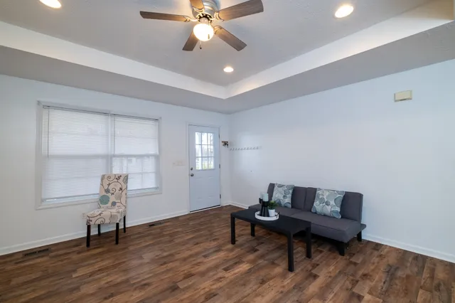 a living room with furniture and wooden floor