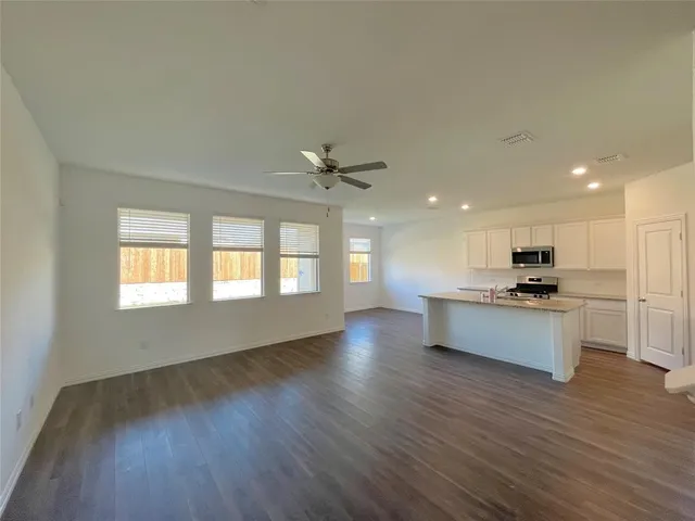 a kitchen with stainless steel appliances granite countertop white cabinets and a stove