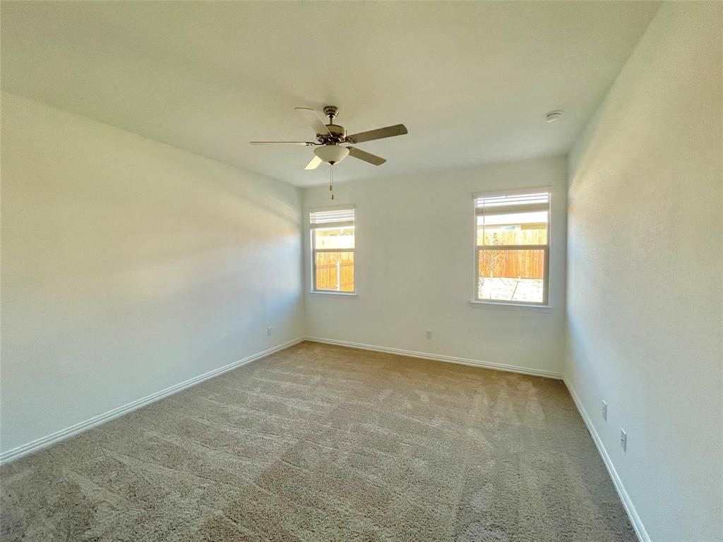 768 Hawthorn Street Princeton, TX 75407 - Photo 13 of 23 an empty room with windows and fan