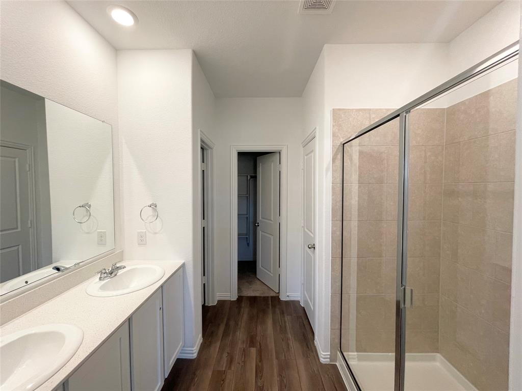 768 Hawthorn Street Princeton, TX 75407 - Photo 14 of 23 a bathroom with a double vanity sink and mirror