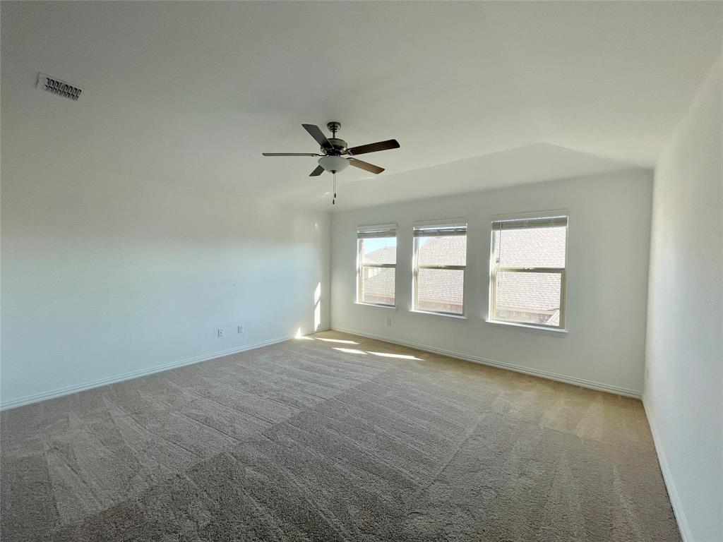 768 Hawthorn Street Princeton, TX 75407 - Photo 17 of 23 an empty room with windows and ceiling fan view