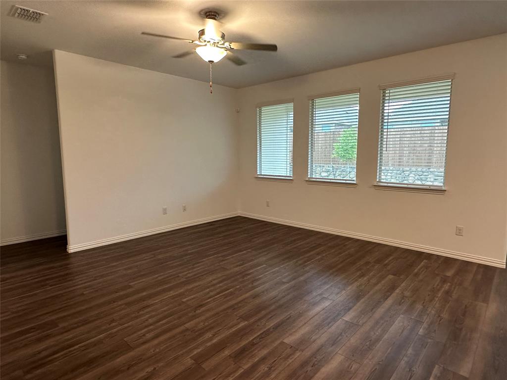 768 Hawthorn Street Princeton, TX 75407 - Photo 19 of 23 a view of an empty room with wooden floor and a window