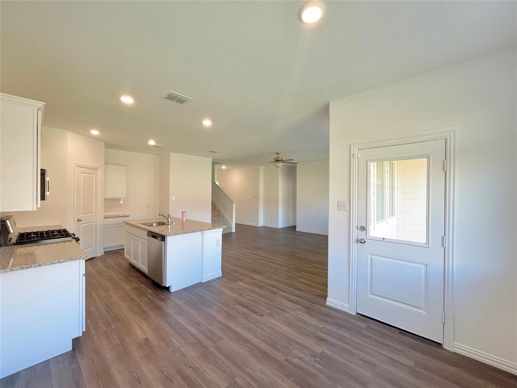 768 Hawthorn Street Princeton, TX 75407 - Photo 3 of 23 a view of kitchen with kitchen island wooden floors wooden floor and center island
