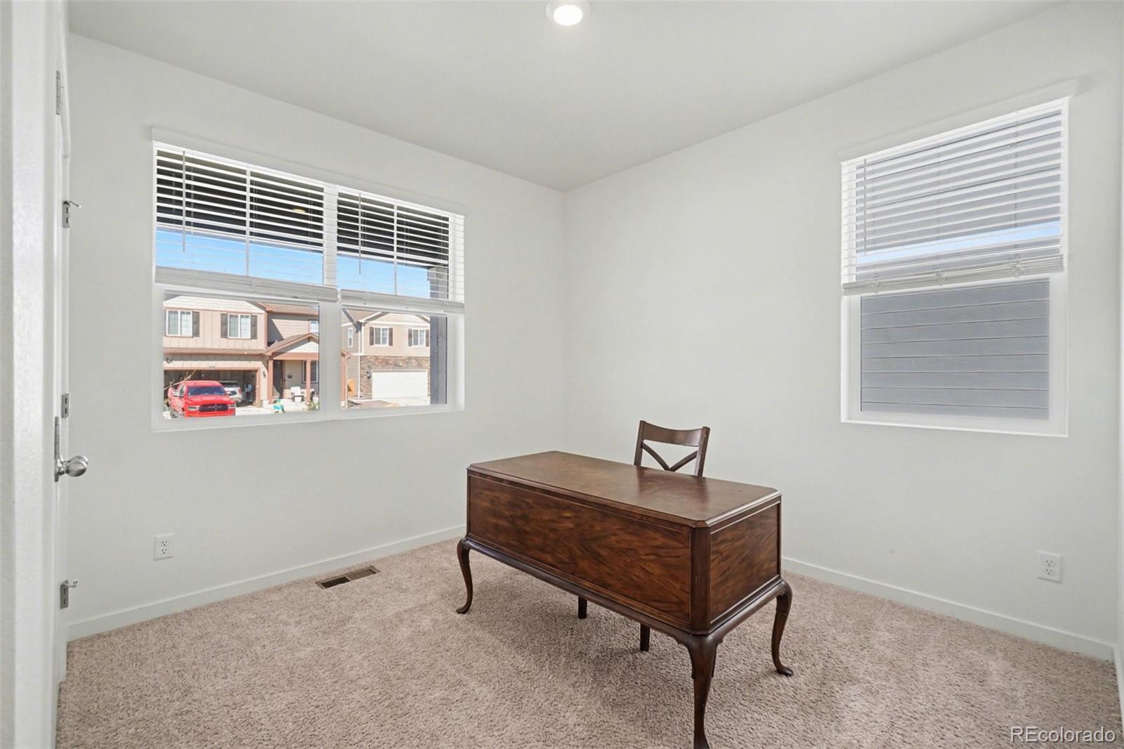 2226 Monte Vista Court Fort Lupton, CO 80621 - Photo 12 of 25 a living room with furniture and a window