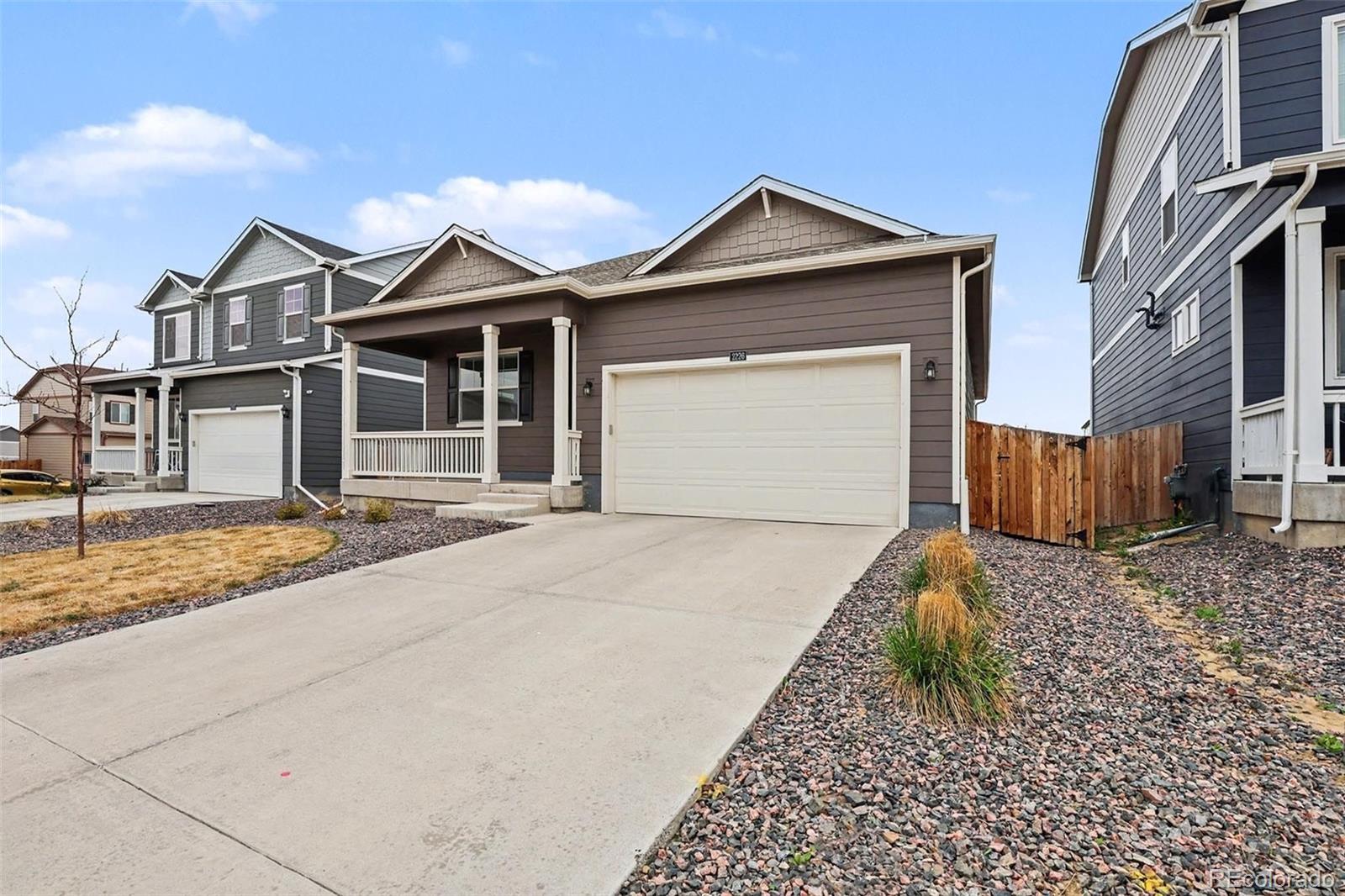 2226 Monte Vista Court Fort Lupton, CO 80621 - Photo 3 of 25 a front view of a house with a yard and garage