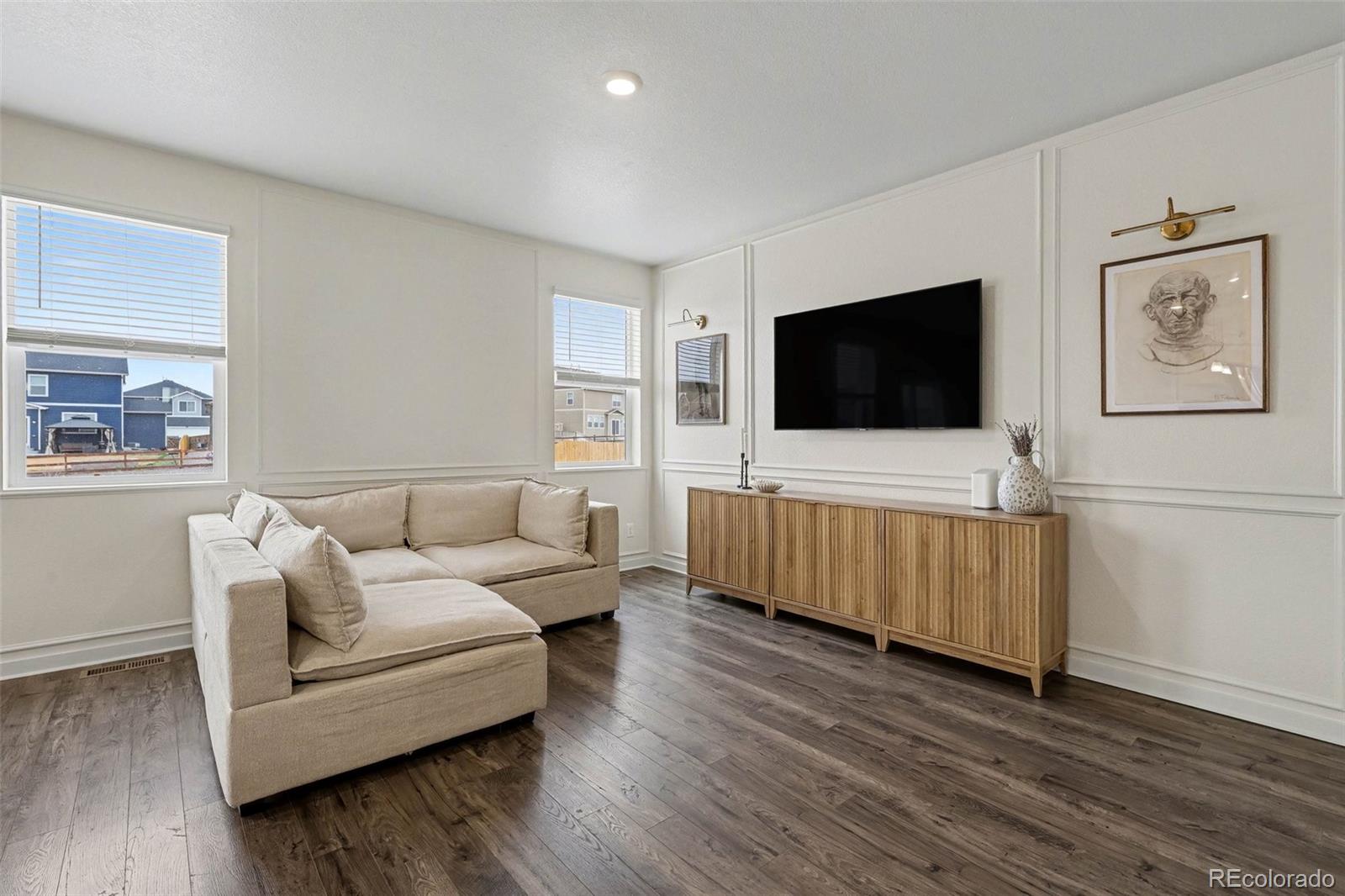 2226 Monte Vista Court Fort Lupton, CO 80621 - Photo 5 of 25 a living room with furniture and a flat screen tv