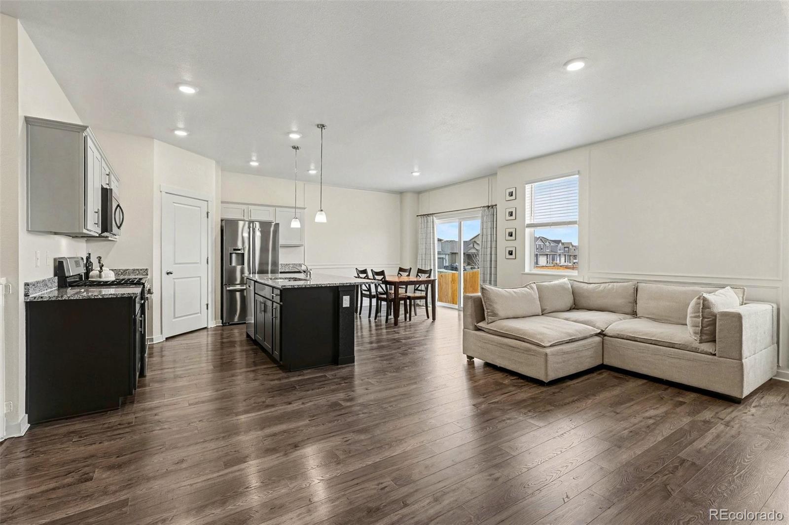 2226 Monte Vista Court Fort Lupton, CO 80621 - Photo 6 of 25 a living room with furniture and wooden floor