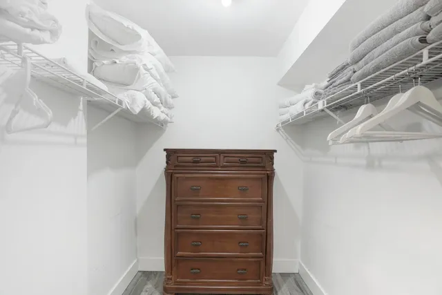 a bedroom with a large bed and a chandelier